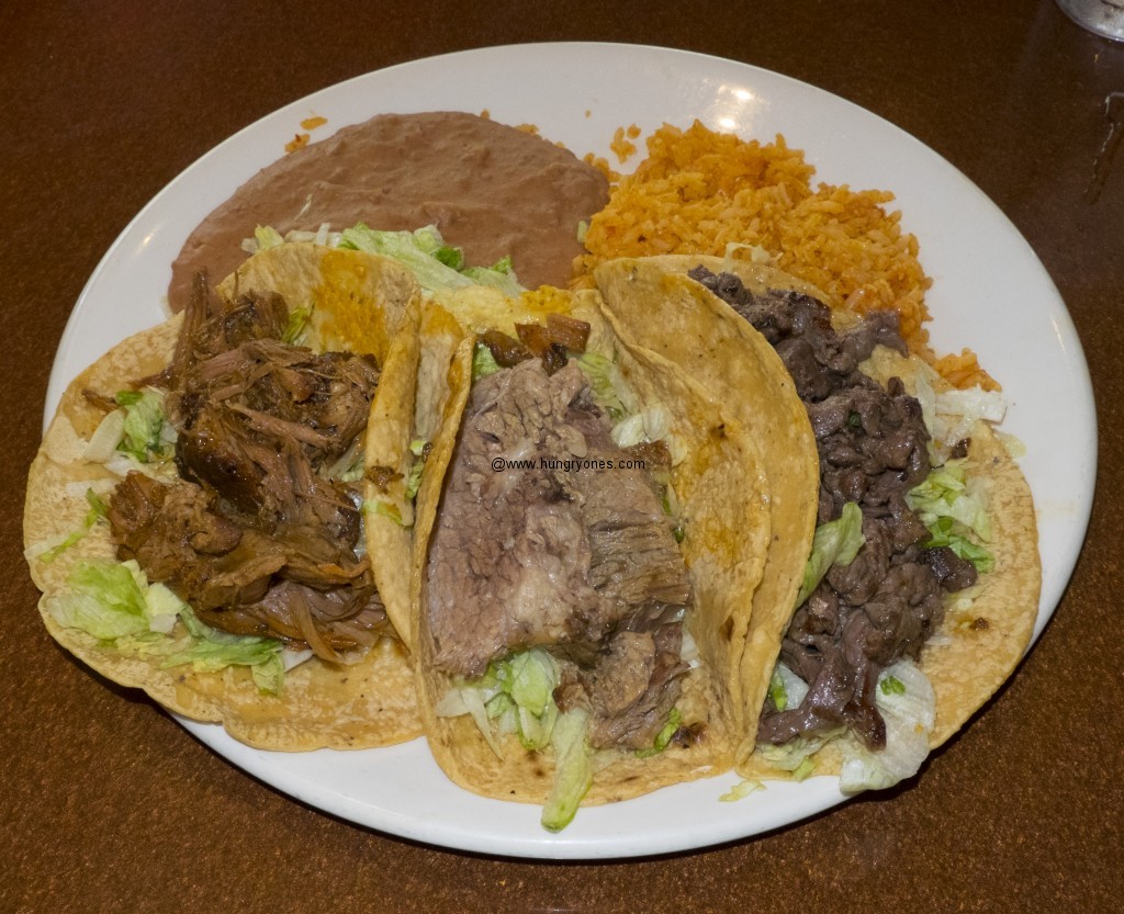 Carnitas, brisket, and carne asada taco.